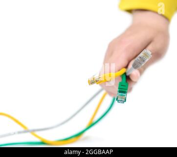 Internet cables in the hand of a technician on a white background Stock Photo