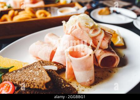 Whole raw fish between slices of bread on a blue colored table. Eating raw  fish concept with a frozen dorado fish in a sandwich Stock Photo - Alamy