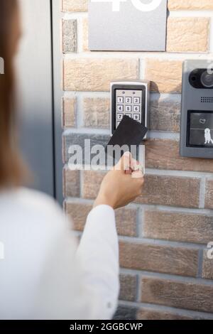 Attaching card to the electronic reader to access the office or apartment Stock Photo