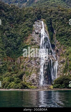 Stirling Falls; waterfall, mountainside, green vegetation, nature, cascading water, movement, high, Milford Sound, Fiordland National Park, Te Anau, N Stock Photo