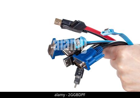 Bunch of computer cables in women's hand isolated on white background. Bundle of computer interface cables with different connectors Stock Photo