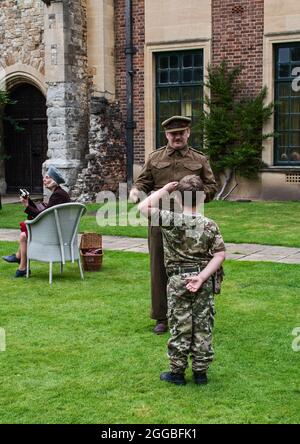 Yuong lad salutes a '1940s army officer' at Eltham Palace event. Stock Photo