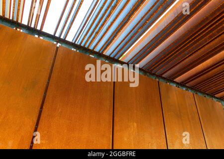 Rust-coated sheet metal forming an abstract image, corten panel and louvers Stock Photo