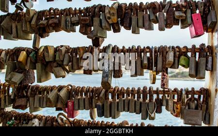 Bunch of rusty love locks hanging on the bridge in Sliema, Malta. Stock Photo