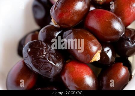 Beautiful Tasty Fresh Dark Red Dates Fruit Or Date Palm In White Background. Selective Focus Stock Photo