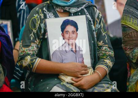 Relatives hold portraits of disappeared family members at an event to mark the International Day of the Disappeared, at National Press Club, in Dhaka, Bangladesh, on 30 August 2021. Families of the victims of enforced disappearance have demanded return of their loved ones on the International Day of the Victims of Enforced Disappearances. Mayer Daak, a platform of the families of the people who fell victim to enforced disappearance, organized a programme where relatives of disappeared people joined. (Photo by Suvra Kanti Das/Sipa USA) Stock Photo