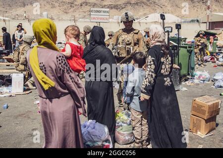Kabul, Afghanistan. 28th Aug, 2021. A U.S. Marine with the 24th Marine Expeditionary Unit processes evacuees at Hamid Karzai International Airport during Operation Allies Refuge August 28, 2021 in Kabul, Afghanistan. Credit: Planetpix/Alamy Live News Stock Photo