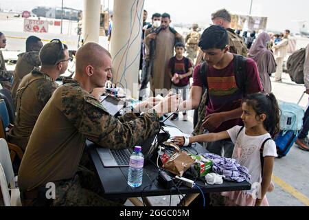 Kabul, Afghanistan. 28th Aug, 2021. A U.S. Marine with the 24th Marine Expeditionary Unit processes evacuees at Hamid Karzai International Airport during Operation Allies Refuge August 28, 2021 in Kabul, Afghanistan. Credit: Planetpix/Alamy Live News Stock Photo