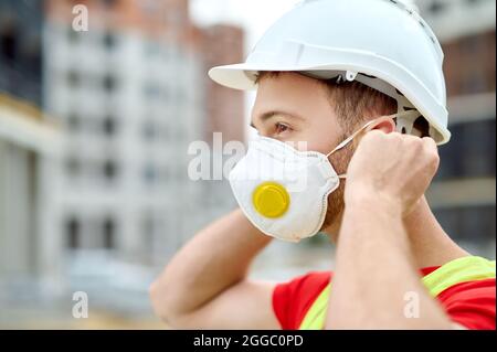 Experienced concentrated tranquil male builder preparing for work Stock Photo