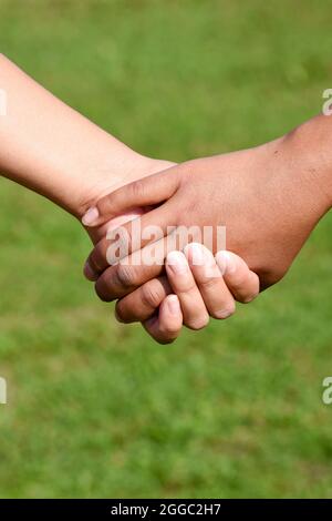 Hands holding each other Stock Photo