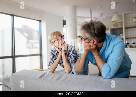 Handsome senior man and attractive old woman are having relationship problems Stock Photo