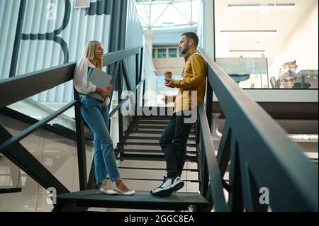 Two managers talks on stairs in IT office Stock Photo