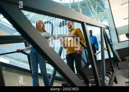Team of happy managers on stairs in IT office Stock Photo