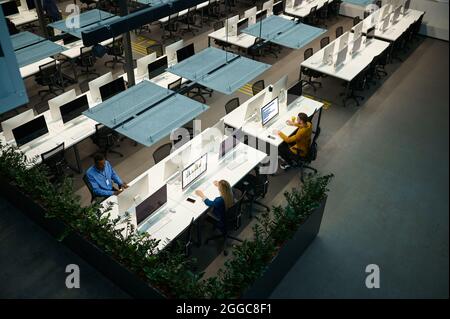 Managers works on computers in IT office, top view Stock Photo