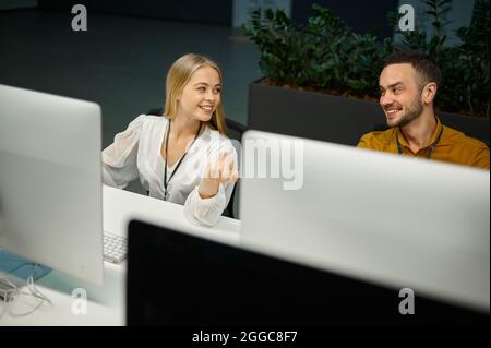 Two managers works on computers in IT office Stock Photo