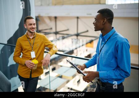 Two managers talking on the balcony in IT office Stock Photo