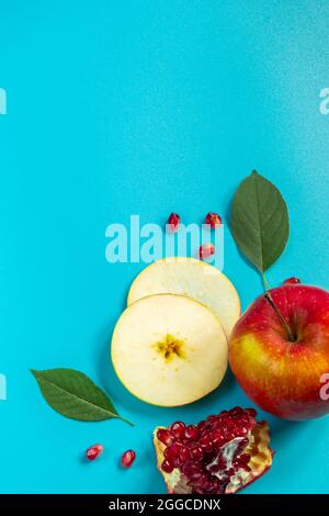 Honey, apples and pomegranates on a blue background. Happy Rosh Hashanah. Jewish traditional religious holiday. Place for your text. Stock Photo