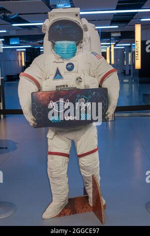 Transinne, Wallonia, Belgium - August 10, 2021: Euro Space Center. Covid-19 health warning and safety instruction in style as given by fake astronaut. Stock Photo