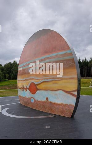 Transinne, Wallonia, Belgium - August 10, 2021: Euro Space Center domain. Portrait of Jupiter Planet colored symbol under rainy cloudscape. Green fore Stock Photo
