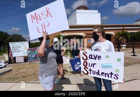 Viera, United States. 30th Aug, 2021. People demonstrate with placards outside an emergency meeting of the Brevard County, Florida School Board in Viera to discuss whether face masks in local schools should be mandatory. An executive order signed by Florida Governor Ron DeSantis banning mask mandates in schools was thrown out by a Florida judge on Friday. (Photo by Paul Hennessy/SOPA Images/Sipa USA) Credit: Sipa USA/Alamy Live News Stock Photo