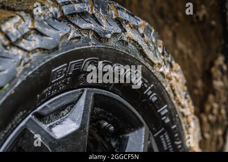 MOSCOW, RUSSIA - MAY 08, 2021 The BFGoodrich All-Terrain and mud terrain tires close up view with raindrops and lot of dirt. Stock Photo