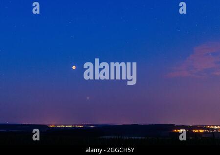 red moon of the total lunar eclipse with mars under a rural eifel landscape on July 27, 2018, Germany Stock Photo