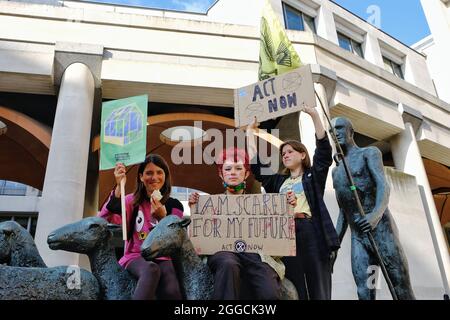 London, UK. Young protesters hold up placards, one saying 'I am scared for my future' at an Extinction Rebellion protest in the City of London.