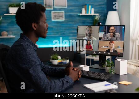 Man student having online webinar with remote teachers working at marketing project ideas during univeristy videocall meeting conference. Videoconference telework teleconference on computer screen Stock Photo