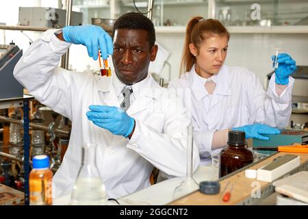 Worried lab technicians checking for result of unhappy experiment Stock Photo