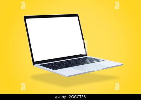 Laptop computer with blank screen, floating on a yellow background. Stock Photo