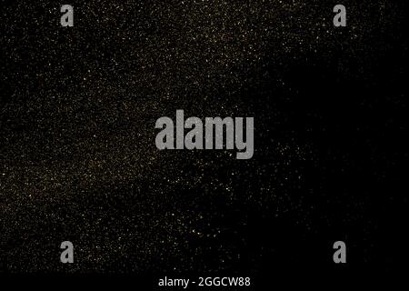 Gold Glitter Texture Isolated on Black Background. Golden stardust. Amber Particles Color. Sparkles Rain. Vector Illustration, Eps 10. Stock Vector
