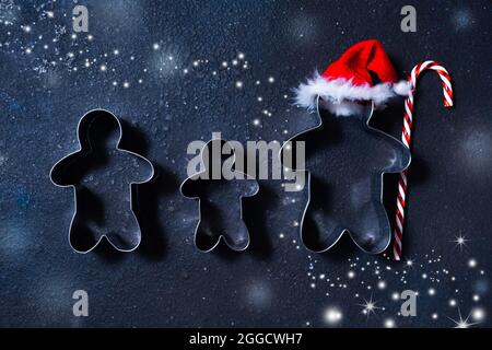 Christmas cookie cutters in shape of gingerbread mans. Happy family holidays concept. Stock Photo