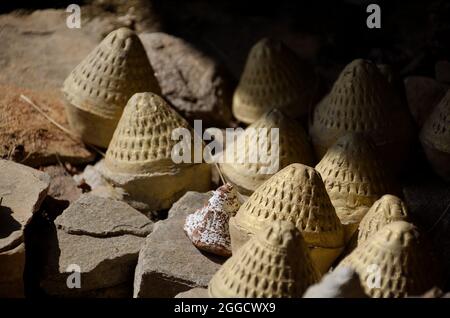 Close-up of Tsa-Tsas: clay votives in the shape of cylindrical cones or stupas, placed along the Paro Taktsang (Tiger Nest's) trail, Bhutan Stock Photo