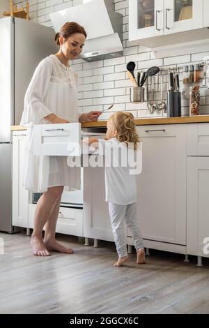 Top view modern housewife tidying up kitchen cupboard during general cleaning or tidying up Stock Photo