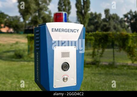 Red emergency police SOS call button alarm box with light bar, cctv camera and speaker device for urgent comunication on city street. Modern smart Stock Photo