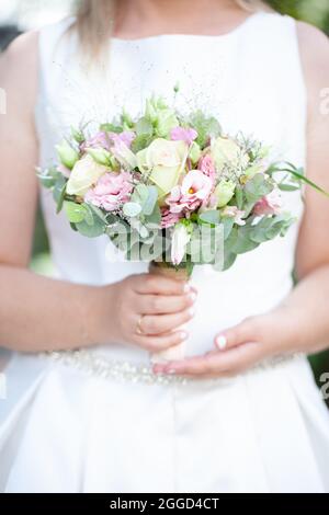beautiful wedding bouquet in the hands of the bride. High quality photo Stock Photo