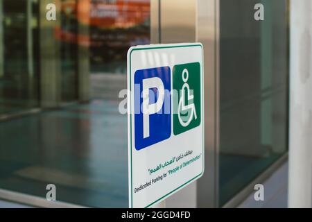 White parking sign on the street showing direction for people and cars outdoor Stock Photo