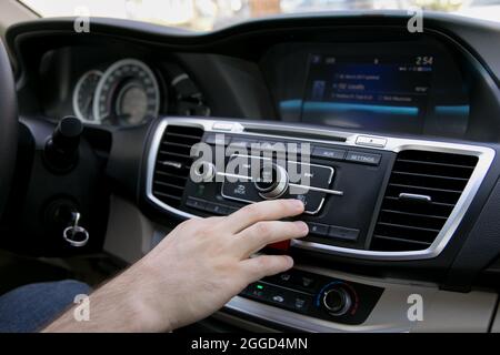Person Touch a Vehicle Car Control Panel Center Consoles Multi Media System of Driving Car Stock Photo