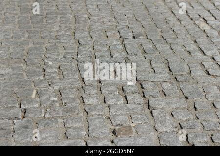 Ancient road, laid from sidewalk coarse stone blocks Stock Photo