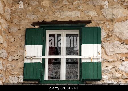 Window with wooden shutters on a house Stock Photo