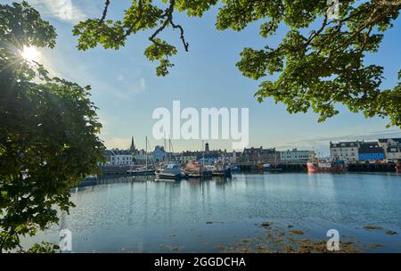 Stornoway harbour viewed from Lews Castle grounds on sunny summers day. Stock Photo
