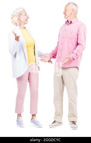 Vertical full length shot of senior Caucasian man and woman wearing casual clothes feeling surprised with good news Stock Photo