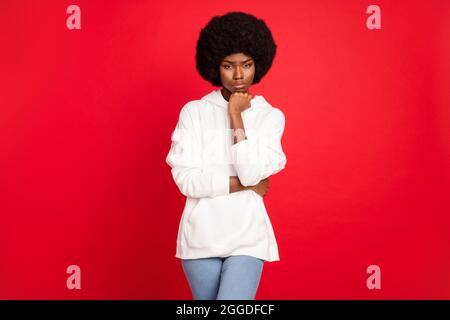 Photo of sad brunette millennial lady hand face wear white sportswear isolated on red color background Stock Photo