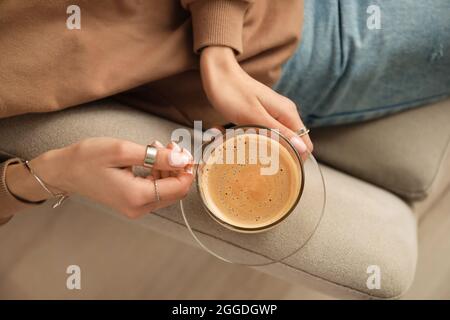 Woman drinking tasty coffee at home, closeup Stock Photo