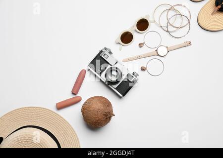 Set of female accessories, photo camera and coconut on white background Stock Photo