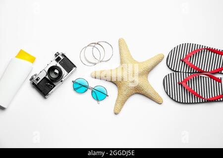 Set of beach accessories and photo camera on white background Stock Photo
