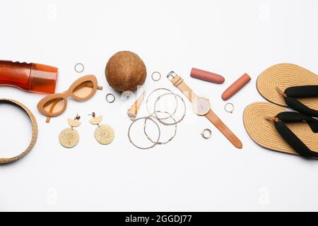 Set of female accessories, sunscreen and coconut on white background Stock Photo