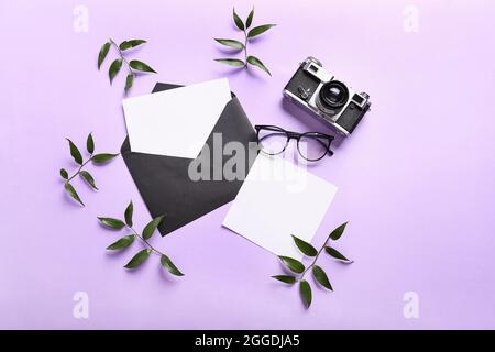 Composition with envelope, blank cards, eyeglasses and photo camera on color background Stock Photo
