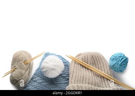 Yarn with knitting needles and hat on white background Stock Photo
