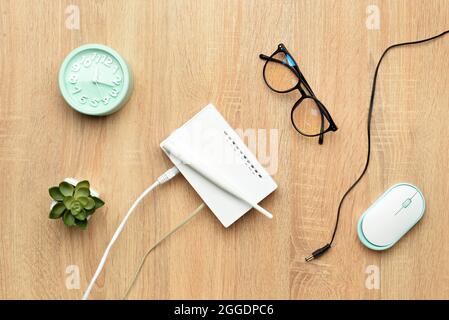 Composition with modern wi-fi router on table Stock Photo